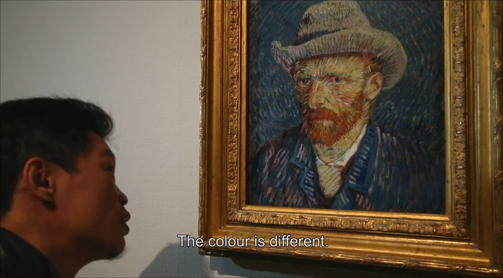 Painter Zhao Xiaoyong looks at a self-potrait of Van Gogh while commenting that colours are different from his own replications